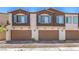 Townhome garages with brick driveways and blue shutters under a clear sky at 219 Cordelia Cove Ave # 513, Henderson, NV 89011