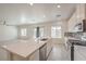 Open kitchen with stainless steel appliances, an island, and views into the living area at 219 Cordelia Cove Ave # 513, Henderson, NV 89011