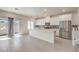 Modern kitchen featuring stainless appliances, a large island, and access to the backyard at 219 Cordelia Cove Ave # 513, Henderson, NV 89011