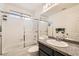 Bathroom featuring a granite countertop, modern sink, and a shower-tub combo with a sliding glass door at 2341 Steinke Ln, Las Vegas, NV 89108