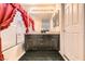Bathroom featuring dual sinks, dark cabinets, a large mirror, and red curtains at 2341 Steinke Ln, Las Vegas, NV 89108