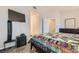 Bedroom featuring a comfortable bed, a mounted television, and natural lighting at 2341 Steinke Ln, Las Vegas, NV 89108