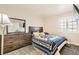 Well-lit bedroom with a plush bed, a wooden dresser, and plantation shutters at 2341 Steinke Ln, Las Vegas, NV 89108