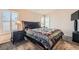 Cozy bedroom featuring a comfortable bed, dark furniture, and plantation shutters at 2341 Steinke Ln, Las Vegas, NV 89108