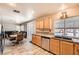 Bright kitchen featuring wood cabinets, stainless steel appliances, granite countertops, and pool views at 2341 Steinke Ln, Las Vegas, NV 89108