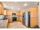 The kitchen featuring wood cabinets, granite countertops and stainless steel appliances at 2341 Steinke Ln, Las Vegas, NV 89108