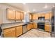 The kitchen featuring wood cabinets, granite countertops and stainless steel appliances at 2341 Steinke Ln, Las Vegas, NV 89108
