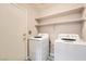 A bright laundry room showcasing white appliances with shelving, offering ample storage space and functionality at 2341 Steinke Ln, Las Vegas, NV 89108