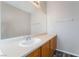 Bathroom featuring a white sink, wooden cabinets, and a large mirror above the vanity at 2407 Belt Buckley Dr, Henderson, NV 89002
