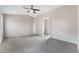 Spacious bedroom featuring neutral walls, carpet, an archway, and a window bringing in natural light at 2407 Belt Buckley Dr, Henderson, NV 89002