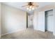 Bedroom featuring neutral walls, carpet, ceiling fan, an open closet, and a doorway leading to another room at 2407 Belt Buckley Dr, Henderson, NV 89002
