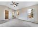 Large bedroom featuring neutral walls, vaulted ceilings, carpet, and windows offering neighborhood views at 2407 Belt Buckley Dr, Henderson, NV 89002