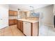 Functional kitchen with wood cabinets, a breakfast bar, and easy access to the adjacent living space at 2407 Belt Buckley Dr, Henderson, NV 89002