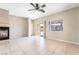Spacious living room featuring a fireplace, tile flooring, ceiling fan, and a sliding glass door at 2407 Belt Buckley Dr, Henderson, NV 89002