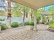 Expansive patio area featuring stone pavers, covered seating, lush plants, and shade canopies at 2451 Tour Edition Dr, Henderson, NV 89074