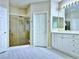 Bright bathroom with a glass enclosed shower, double vanity and modern fixtures at 2451 Tour Edition Dr, Henderson, NV 89074