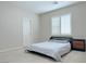 Neutral bedroom with window shutters, carpeted floor, door, and a minimal bed frame at 2451 Tour Edition Dr, Henderson, NV 89074