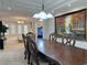 Spacious dining area featuring an extra-long wooden table with decorative chairs at 2451 Tour Edition Dr, Henderson, NV 89074