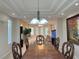Dining room with a large wooden table and chairs, with a view into the living room at 2451 Tour Edition Dr, Henderson, NV 89074