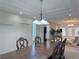 Open-concept dining room flowing to the living room with large wall decor at 2451 Tour Edition Dr, Henderson, NV 89074