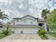 Stately two-story home with a three-car garage and desert landscaping, blending elegance and practicality at 2451 Tour Edition Dr, Henderson, NV 89074