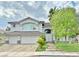 Beautiful two-story house featuring desert landscaping, a three-car garage, and manicured front lawn at 2451 Tour Edition Dr, Henderson, NV 89074