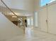 Inviting foyer with a staircase, a double-door entry and an open view of the stylish living area at 2451 Tour Edition Dr, Henderson, NV 89074