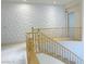 Hallway with 3D wall design and natural wood railings, and a view of the staircase at 2451 Tour Edition Dr, Henderson, NV 89074
