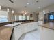 Bright kitchen with stone countertops, white cabinets, stainless appliances, and views of the outdoor scenery at 2451 Tour Edition Dr, Henderson, NV 89074