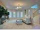 Bright living room with large windows, white sectional sofa, and a view of the staircase at 2451 Tour Edition Dr, Henderson, NV 89074