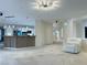 Open living room area offering contemporary lighting and access to the kitchen and entryway at 2451 Tour Edition Dr, Henderson, NV 89074