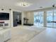Open living area with modern lighting, an exercise machine, and sliding doors to the patio at 2451 Tour Edition Dr, Henderson, NV 89074