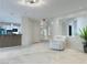 Open living room area offering contemporary lighting and access to the kitchen and entryway at 2451 Tour Edition Dr, Henderson, NV 89074