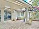 Covered patio with brick flooring, view of greenery, pergola with flowers, and access to the house at 2451 Tour Edition Dr, Henderson, NV 89074