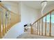 Elegant staircase featuring a modern chandelier and natural wood railings in a bright, open space at 2451 Tour Edition Dr, Henderson, NV 89074