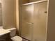 Neutral bathroom featuring frosted glass shower doors, a toilet and sink with traditional vanity at 2609 Sierra Sage St, Las Vegas, NV 89134