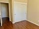 Bedroom featuring wood floors, light tan walls, and sliding closet doors at 2609 Sierra Sage St, Las Vegas, NV 89134