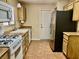 Functional kitchen featuring linoleum floors, stainless steel refrigerator, and gas range at 2609 Sierra Sage St, Las Vegas, NV 89134