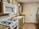 Functional kitchen featuring linoleum floors, stainless steel refrigerator, and gas range at 2609 Sierra Sage St, Las Vegas, NV 89134