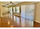 Bright living room featuring hardwood floors, a ceiling fan, and mirrored wall at 2609 Sierra Sage St, Las Vegas, NV 89134