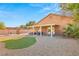 Large backyard with a covered patio, low maintenance yard, and hot tub at 2720 Mickey Mantle Ct, Las Vegas, NV 89108