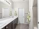 Bathroom with a modern vanity, dual sinks, and a shower with a curtain at 2720 Mickey Mantle Ct, Las Vegas, NV 89108