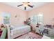 Bright bedroom with a day bed, desk, and pink unicorn rug at 2720 Mickey Mantle Ct, Las Vegas, NV 89108