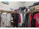 Walk-in closet with clothing and shoe boxes on shelves and hanging rods at 2720 Mickey Mantle Ct, Las Vegas, NV 89108