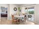 Cozy dining area with access to the patio through sliding glass doors at 2720 Mickey Mantle Ct, Las Vegas, NV 89108