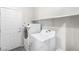 Functional laundry room with washer, dryer, and shelving space at 2720 Mickey Mantle Ct, Las Vegas, NV 89108