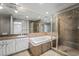 Luxurious bathroom featuring a soaking tub, separate shower, and granite vanity at 2809 Mason Ave, Las Vegas, NV 89102