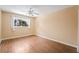 Bedroom with wood laminate flooring, ceiling fan, and window with natural light at 2809 Mason Ave, Las Vegas, NV 89102