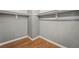 Walk-in closet with built-in shelving and laminate wood flooring at 2809 Mason Ave, Las Vegas, NV 89102