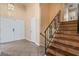 Spacious entryway featuring tile flooring, wooden stairs, and a modern metal railing at 2809 Mason Ave, Las Vegas, NV 89102